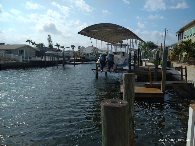 dock area with boat lift and a water view