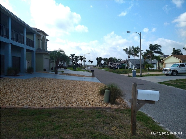 view of road featuring a residential view and street lights