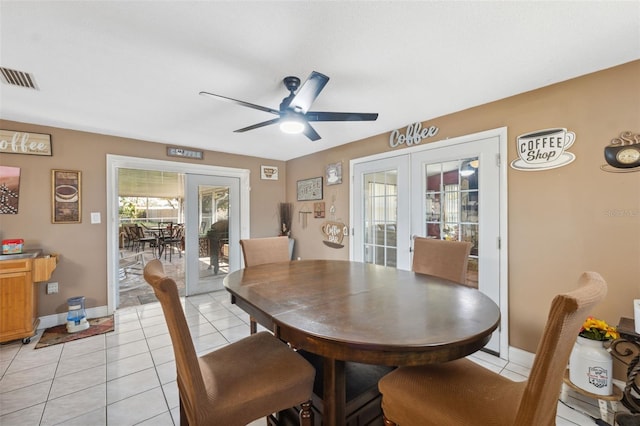 dining space featuring visible vents, a ceiling fan, french doors, light tile patterned floors, and baseboards