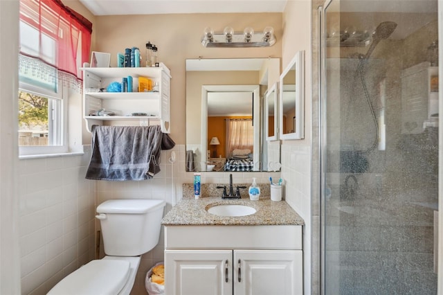 full bathroom featuring vanity, tile walls, toilet, and a stall shower