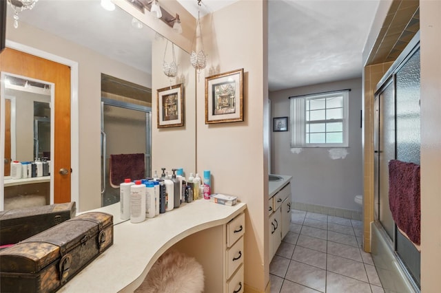 bathroom featuring vanity, baseboards, and tile patterned flooring