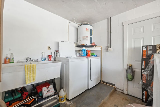 laundry area with laundry area, concrete block wall, washing machine and dryer, and electric water heater