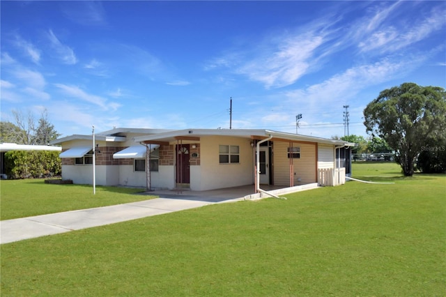 single story home featuring a carport and a front yard