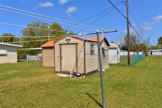 view of shed featuring fence