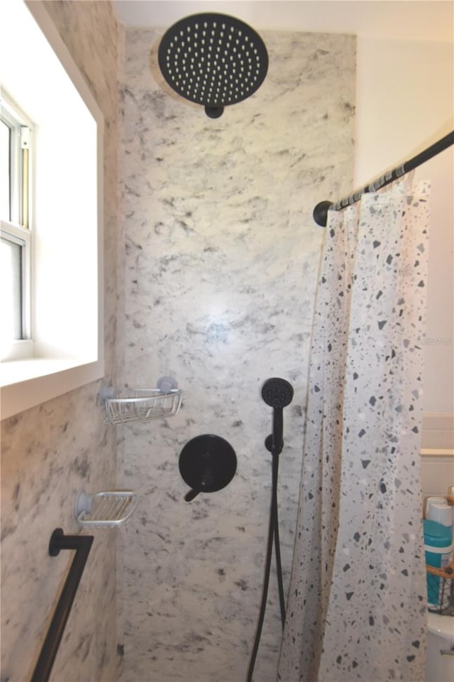 full bath featuring tiled shower