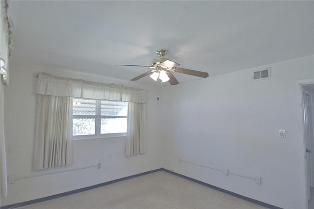 unfurnished room with visible vents, baseboards, and a ceiling fan