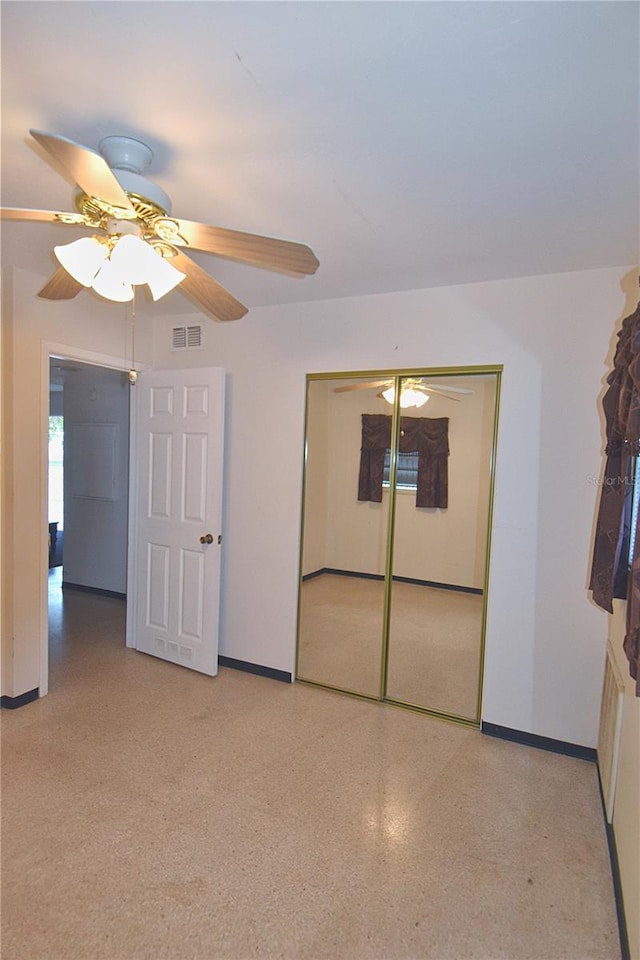 unfurnished bedroom with a closet, visible vents, a ceiling fan, and baseboards