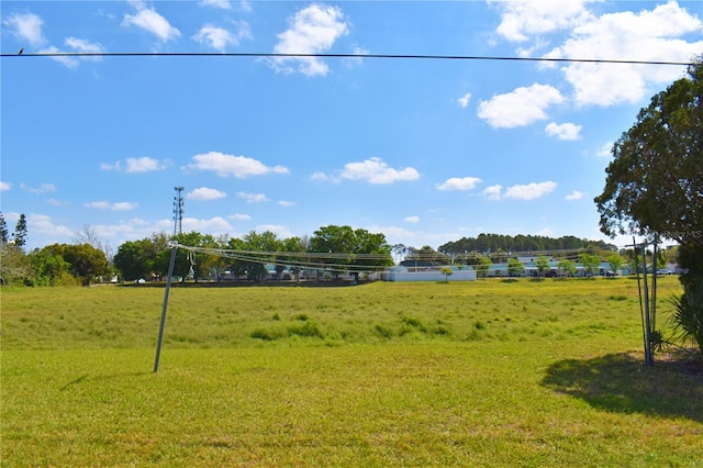 view of community with a lawn and volleyball court