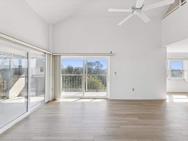 5557 Sea Forest Dr Unit 318, New Port Richey, FL 34652 - unfurnished room featuring baseboards, high vaulted ceiling, wood finished floors, and a ceiling fan