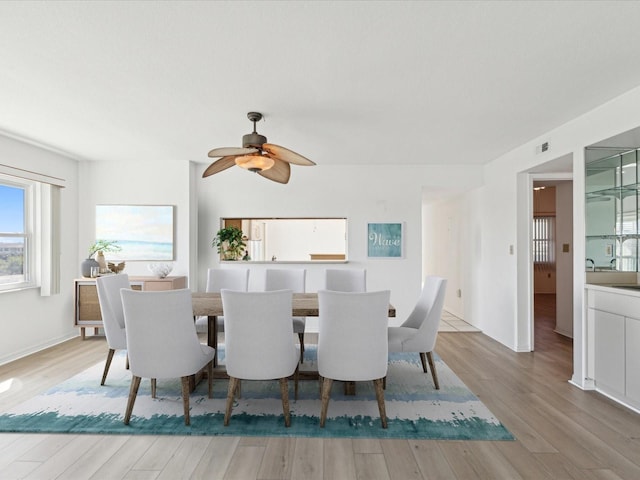5557 Sea Forest Dr Unit 318, New Port Richey, FL 34652 - dining space featuring light wood finished floors, visible vents, and a ceiling fan