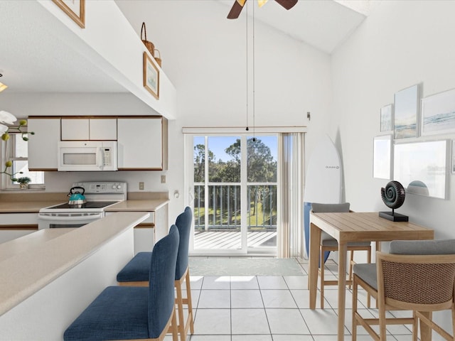 5557 Sea Forest Dr Unit 318, New Port Richey, FL 34652 - kitchen with a ceiling fan, light countertops, white appliances, light tile patterned floors, and white cabinets
