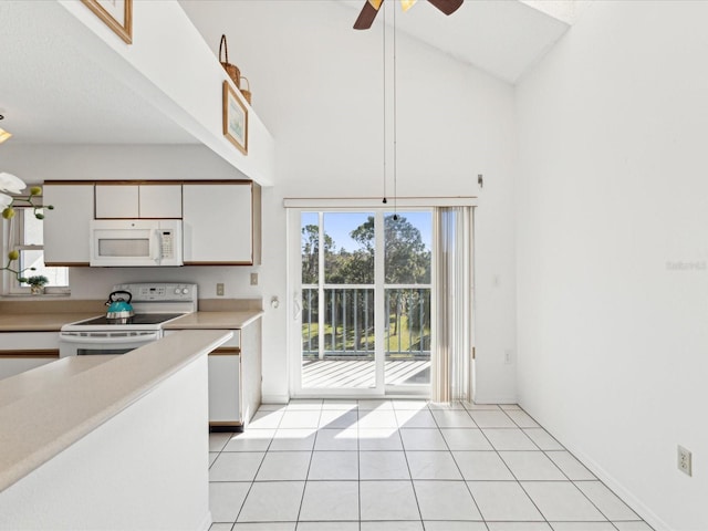 5557 Sea Forest Dr Unit 318, New Port Richey, FL 34652 - kitchen featuring light countertops, white appliances, light tile patterned floors, white cabinets, and a ceiling fan