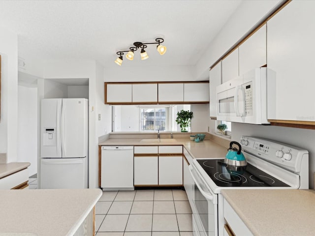 5557 Sea Forest Dr Unit 318, New Port Richey, FL 34652 - kitchen with light countertops, white appliances, white cabinetry, a sink, and light tile patterned floors