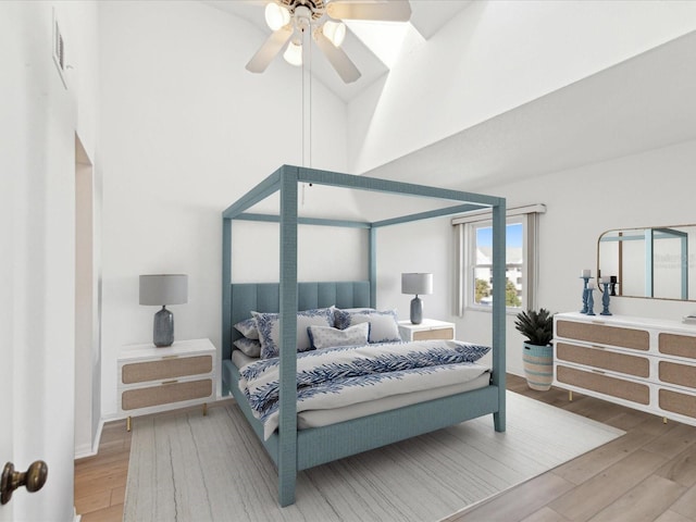 5557 Sea Forest Dr Unit 318, New Port Richey, FL 34652 - bedroom featuring a ceiling fan, a towering ceiling, visible vents, and wood finished floors