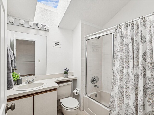 5557 Sea Forest Dr Unit 318, New Port Richey, FL 34652 - bathroom with vanity, shower / tub combo, toilet, vaulted ceiling with skylight, and visible vents