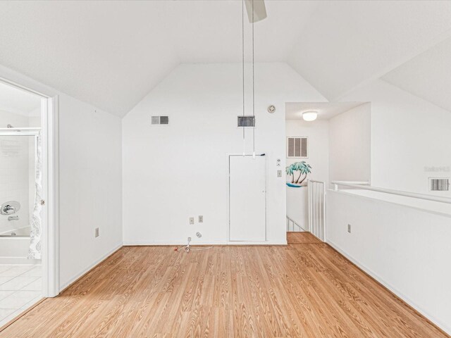 5557 Sea Forest Dr Unit 318, New Port Richey, FL 34652 - additional living space featuring visible vents, light wood-style flooring, and vaulted ceiling