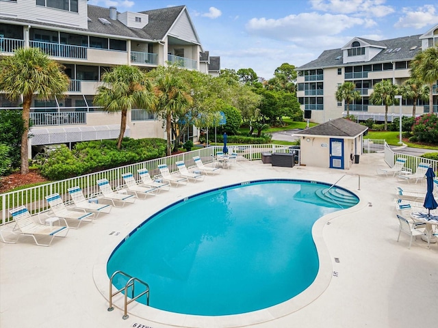 5557 Sea Forest Dr Unit 318, New Port Richey, FL 34652 - community pool with fence and a patio