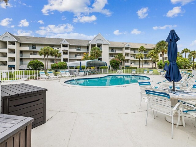 5557 Sea Forest Dr Unit 318, New Port Richey, FL 34652 - pool with fence and a patio area