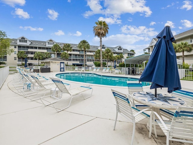 5557 Sea Forest Dr Unit 318, New Port Richey, FL 34652 - community pool featuring fence and a patio