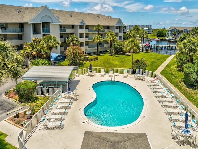 5557 Sea Forest Dr Unit 318, New Port Richey, FL 34652 - pool featuring fence, a patio, a residential view, a water view, and a yard