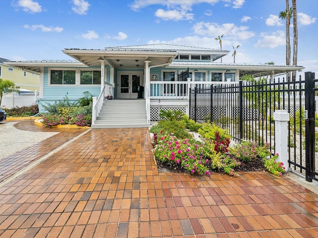 5557 Sea Forest Dr Unit 318, New Port Richey, FL 34652 - view of front of property with french doors, a porch, and fence
