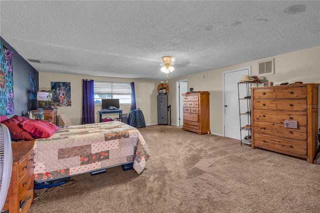 carpeted bedroom featuring a textured ceiling, visible vents, and ceiling fan