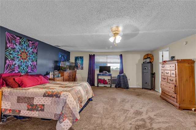 bedroom featuring baseboards, carpet floors, a textured ceiling, and ceiling fan