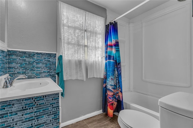 full bath featuring tile patterned floors, toilet, shower / bath combo, a sink, and tile walls