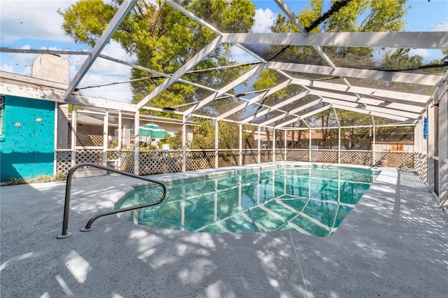 view of swimming pool featuring glass enclosure and a fenced in pool