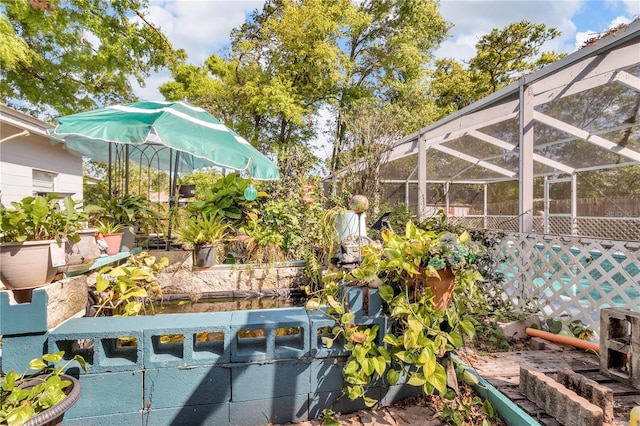 view of yard with a lanai and fence