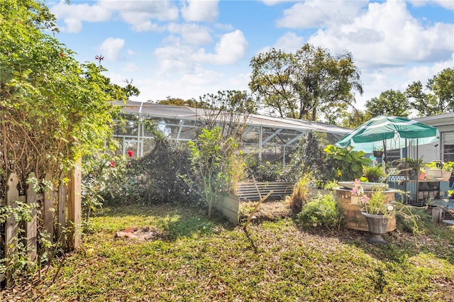 view of yard featuring glass enclosure