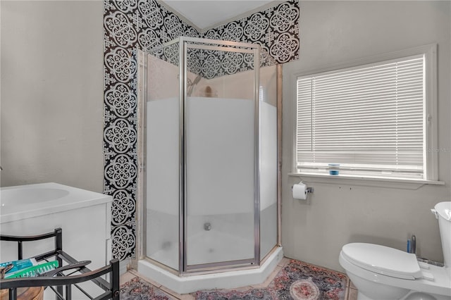 bathroom with a shower stall and toilet