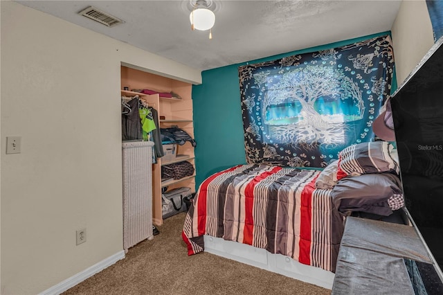 carpeted bedroom featuring baseboards and visible vents