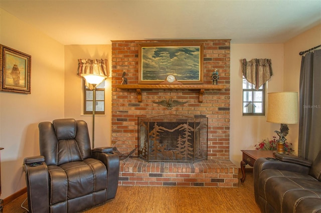 living area featuring a brick fireplace