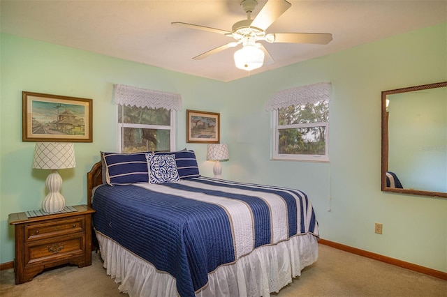 bedroom with carpet flooring, baseboards, and a ceiling fan