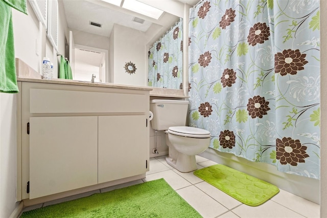 bathroom featuring visible vents, toilet, vanity, and tile patterned flooring