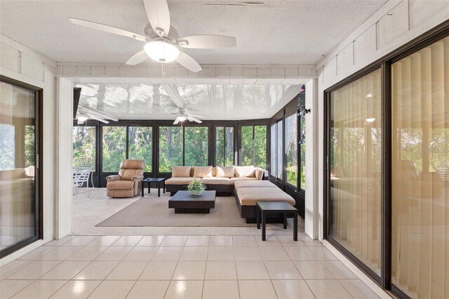 sunroom featuring ceiling fan and outdoor lounge area