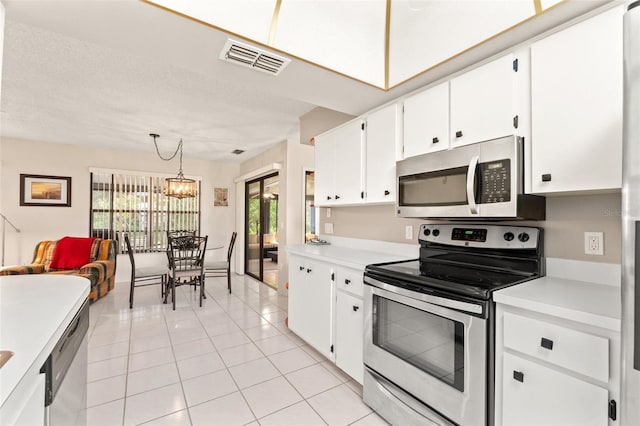 kitchen with visible vents, light countertops, stainless steel appliances, light tile patterned flooring, and white cabinetry