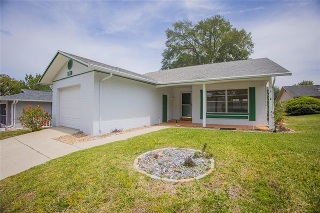single story home featuring a front yard, concrete driveway, brick siding, and a garage