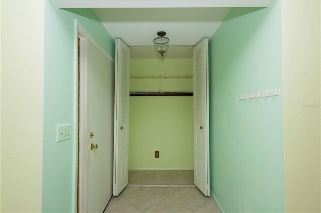 hall with light tile patterned floors