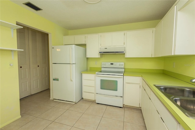 kitchen featuring white appliances, visible vents, light tile patterned flooring, a sink, and extractor fan