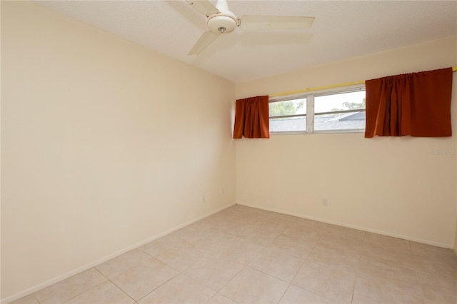 unfurnished room with a textured ceiling, baseboards, and ceiling fan