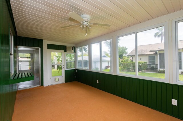 unfurnished sunroom with ceiling fan