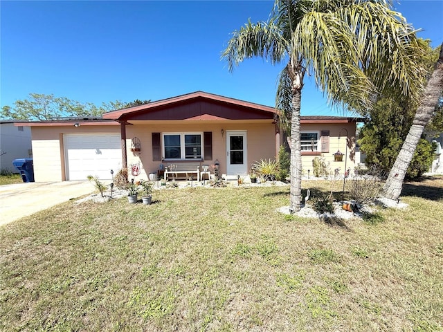 ranch-style house featuring a front lawn, concrete driveway, and a garage