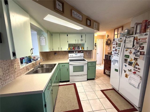 kitchen with white appliances, green cabinetry, open shelves, light tile patterned flooring, and a sink