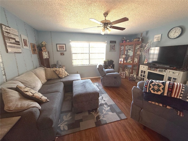 living area featuring a textured ceiling, ceiling fan, and wood finished floors