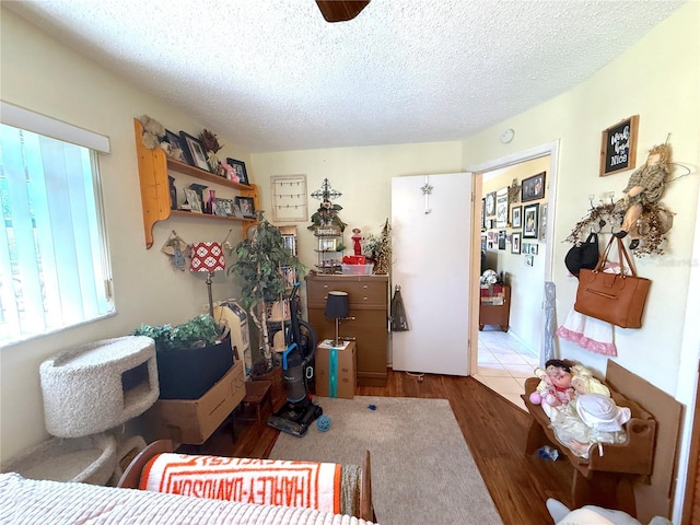 bedroom featuring a textured ceiling and wood finished floors