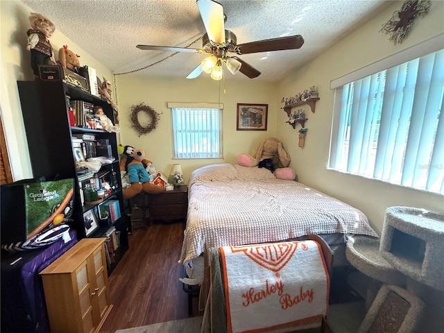 bedroom featuring a textured ceiling, ceiling fan, and wood finished floors