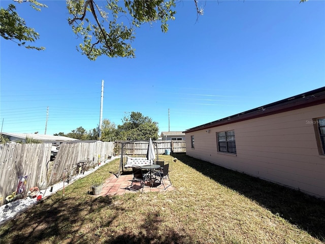 view of yard featuring a patio and a fenced backyard
