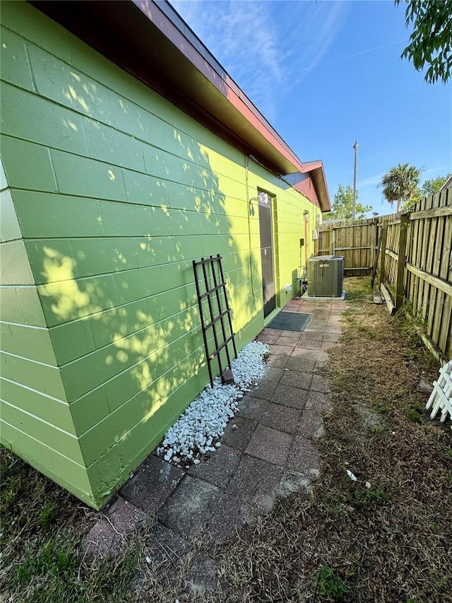 8053 Hixton Dr, Port Richey, FL 34668 - view of home's exterior featuring central AC unit, a fenced backyard, and concrete block siding